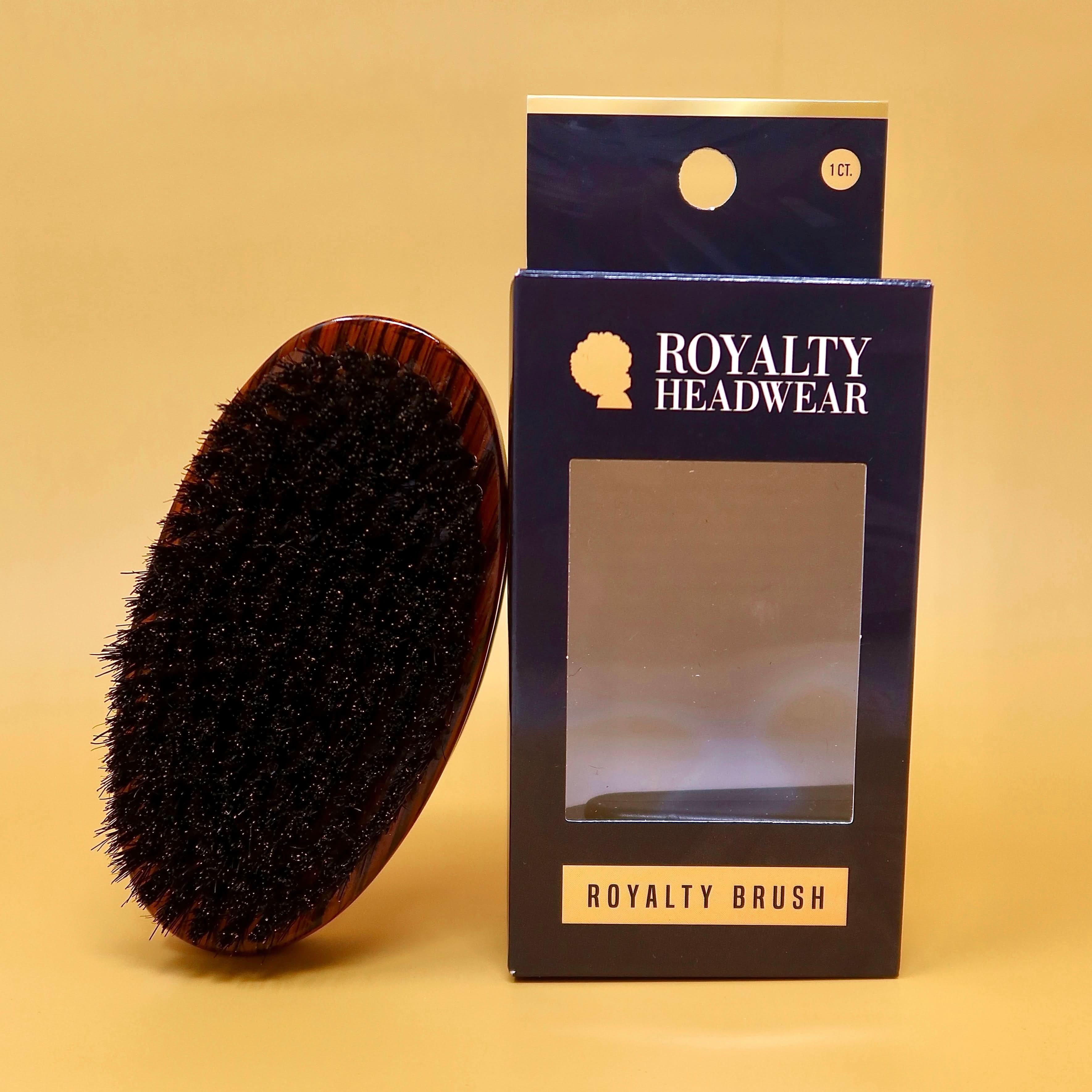 360 Waves Curved Palm Brush with dark bristles and ergonomic wood finish next to Royalty Headwear packaging. Ideal for coarse or curly hair styling.